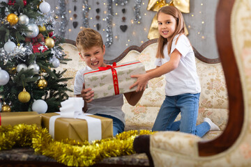 Fototapeta na wymiar Brother and sister open boxes with gifts