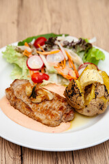 Pork sirloin steak with baked potato and andalouse sauce