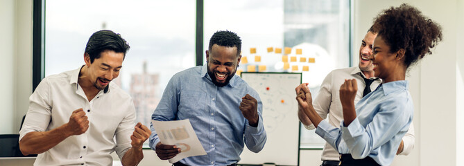 Successful of happy group professional casual business people smiling and laughing to win of celebrating project success.Creative business relaxing and raising hands up in modern office