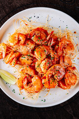 Whole fried big shrimps with seasonings in plate