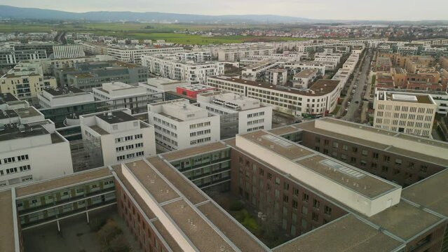 Aerial footage of town development in urban borough. backwards reveal on buildings on Goethe University campus. Frankfurt am Main, Germany