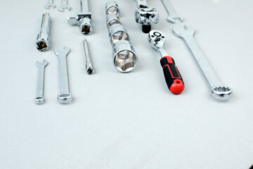 A set of working tools, a hammer, a screwdriver, sockets for an answer on a gray concrete background. Flat lay