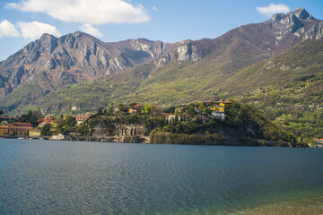 Lake Como from the shore of the city of Lecco. View of the Alps mountains, buildings and the town of Malgrate.
