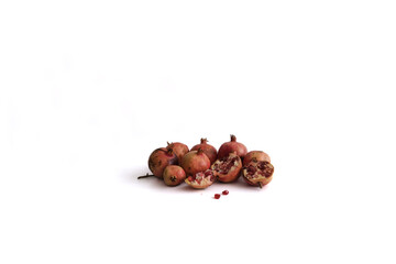 Obraz premium Pomegranate apples and seeds or grains isolated on white background. Minimalist concept.