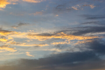 Naklejka na ściany i meble clouds in the sky illuminated by the sun summer evening. background