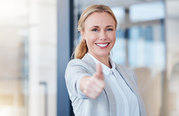Business woman, portrait smile and thumbs up for winning, success or good job at the office. Happy...
