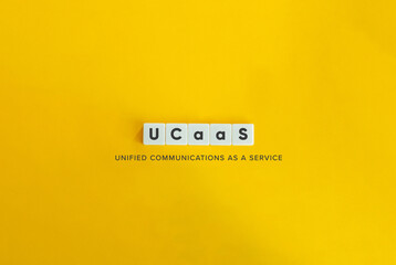 UCaaS acronym (Unified Communications as a Service). Block Letter Tiles on Yellow Background....