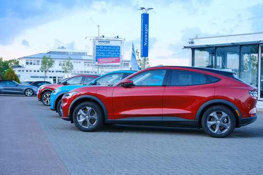 Electric Ford Mustang Mach-E on display in parking lot of company store specializing in sale of electric vehicles, alternative energy, Frankfurt - May 2023