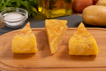 Spanish omelette with potatoes and onion, typical Spanish cuisine. Tortilla espanola. Rustic dark background