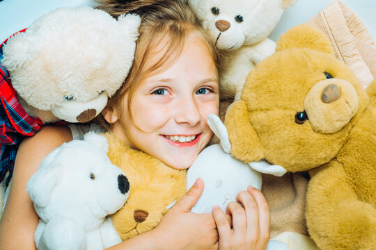 Child hugging teddy bear. Kid funny face near toys. Toys dream. Kid girl dreams near tiys teddy. Childhood dream. Daydreamer child. Dreams and imagination. Dreamy kids.