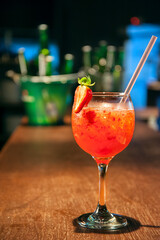Glass with strawberry drink on the bar counter