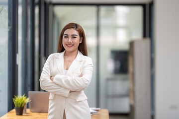 Obraz premium Shot of businesswoman standing front of her table in office. Smile and look at camera.