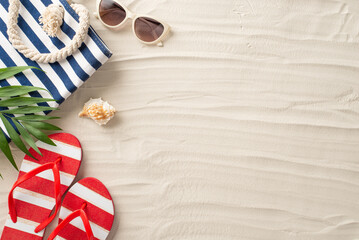 Top-down view of summer travel must-haves on sandy shore: sunglasses, trendy beach bag, flip-flops, shell and palm leaves. Get ready for a sun-soaked adventure!