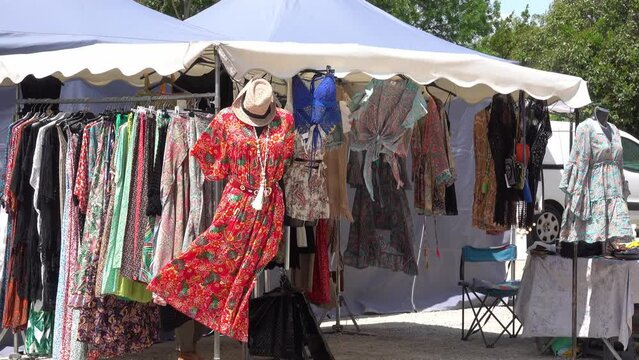 Sale of fashionable clothes in a tent at the clothing market on the street