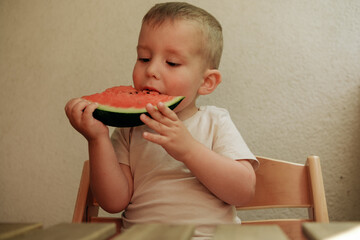 Cute  child  eating red juicy watermelon 