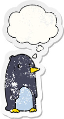 cartoon penguin with thought bubble as a distressed worn sticker
