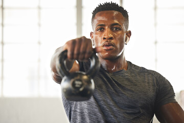 Kettlebell, fitness and black man with gym workout, bodybuilder challenge and training with health and focus. Young athlete or professional person sweating for sports exercise, muscle and power goals