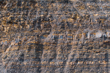 Ancient layers of soil in mountains. Abstract archeological background.