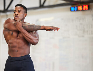 Shirtless black man, stretching arms and fitness in gym with muscle, strong and abs with workout...