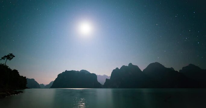 Time-lapse video Night time landscape lake view mountain night sky starry and moon in sky