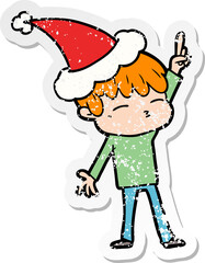 hand drawn distressed sticker cartoon of a curious boy wearing santa hat