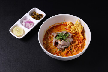 Khao Soi Thai Curry soup isolated in black background