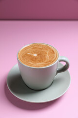 hot cappuccino with latte art on wood background