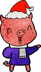 happy hand drawn textured cartoon of a pig in winter clothes wearing santa hat
