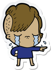 sticker of a cartoon crying girl accusing