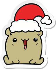 sticker of a cute cartoon bear with christmas hat