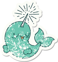 worn old sticker of a tattoo style happy narwhal