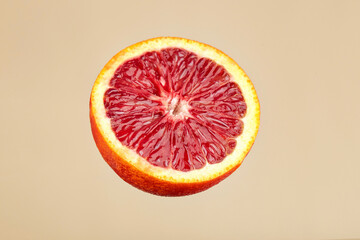 Half an bloody orange. Fresh juicy red orange. Blood red orange - obrazy, fototapety, plakaty