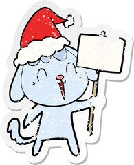 cute hand drawn distressed sticker cartoon of a dog wearing santa hat