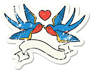 worn old sticker with banner of swallows and a heart