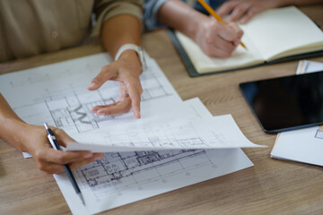Architects interior designer hands working with Blue prints and documents for a home renovation for house design