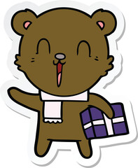 sticker of a happy cartoon bear with gift