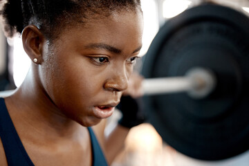 Closeup, weightlifting and barbell with black woman in gym for workout, strong and muscle. Health,...