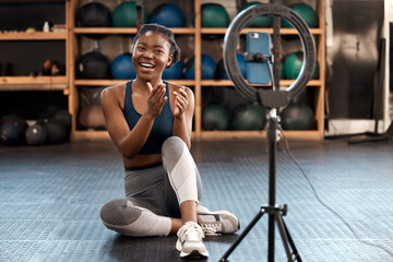 Fitness, woman and phone blog for live stream exercise at gym on platform or app. Influencer,...