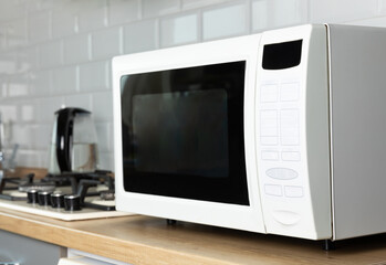 Modern microwave oven in the kitchen. Interior of kitchen with modern microwave oven. Cooking food....