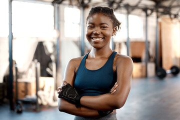 Happy black woman, portrait smile and fitness with arms crossed for workout, exercise or training at the gym. Fit, active or sporty African female person or athlete smiling for healthy wellness - Powered by Adobe