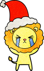 hand drawn textured cartoon of a crying lion wearing santa hat