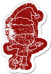 nervous quirky cartoon distressed sticker of a boy wearing santa hat