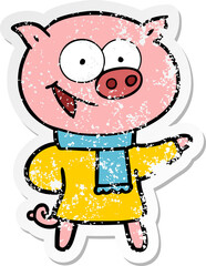 distressed sticker of a cheerful pig wearing winter clothes cartoon