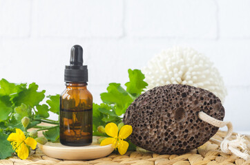 Small bottle of Greater celandine infusion (herbal tincture, extract, oil) and volcanic pumice...