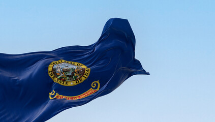 Idaho state flag fluttering in the wind on a clear day