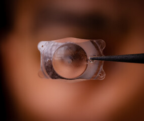 photo of Implantable Collamer Lens ICL for treating refractive errors, infront of a human eye
