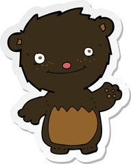 sticker of a cartoon waving black bear cub