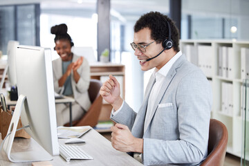 Call center, man and celebrate success with headset and computer at telemarketing or customer service desk. Male agent or consultant excited for bonus, target goal or deal in crm, support or sales