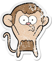 distressed sticker of a cartoon surprised monkey