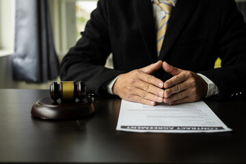 Advice and concept of justice Justice scales and judge hammer, lawyer using pen doing legal work at office, close-up photo